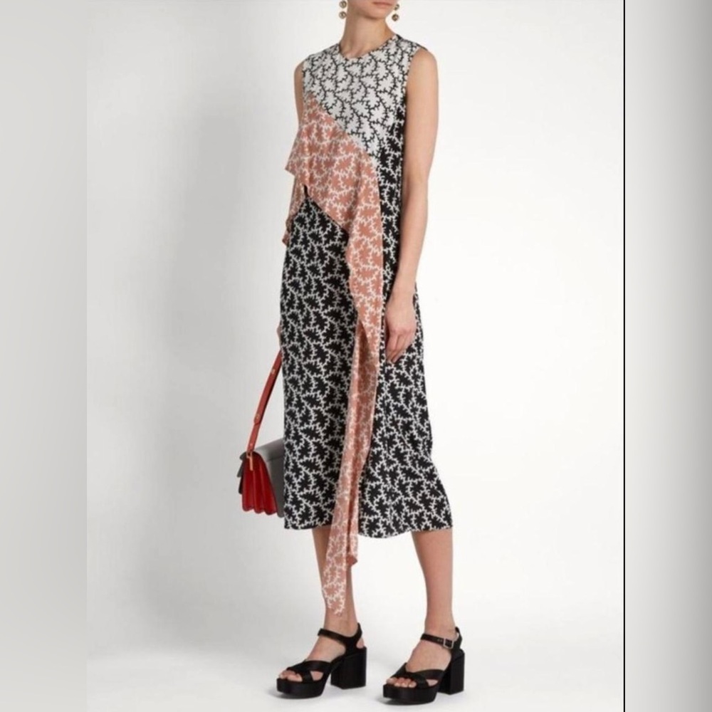 Diane Von Furstenberg Black and White patterned dress with pink ruffle.100% Silk